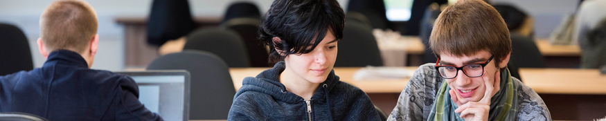 two students studying on laptop